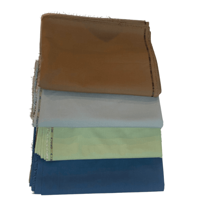 Stack of Grace Bmw men's suiting fabrics in camel, pale blue, pistachio green and denim blue